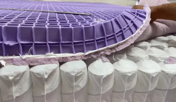 The internal layers of the Purple Mattress, showing the grid layer over pocketed coils, highlighting its construction.