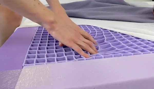 A close-up shot of a sagging area of the mattress, showing a clear dip or indentation where the body typically lies.